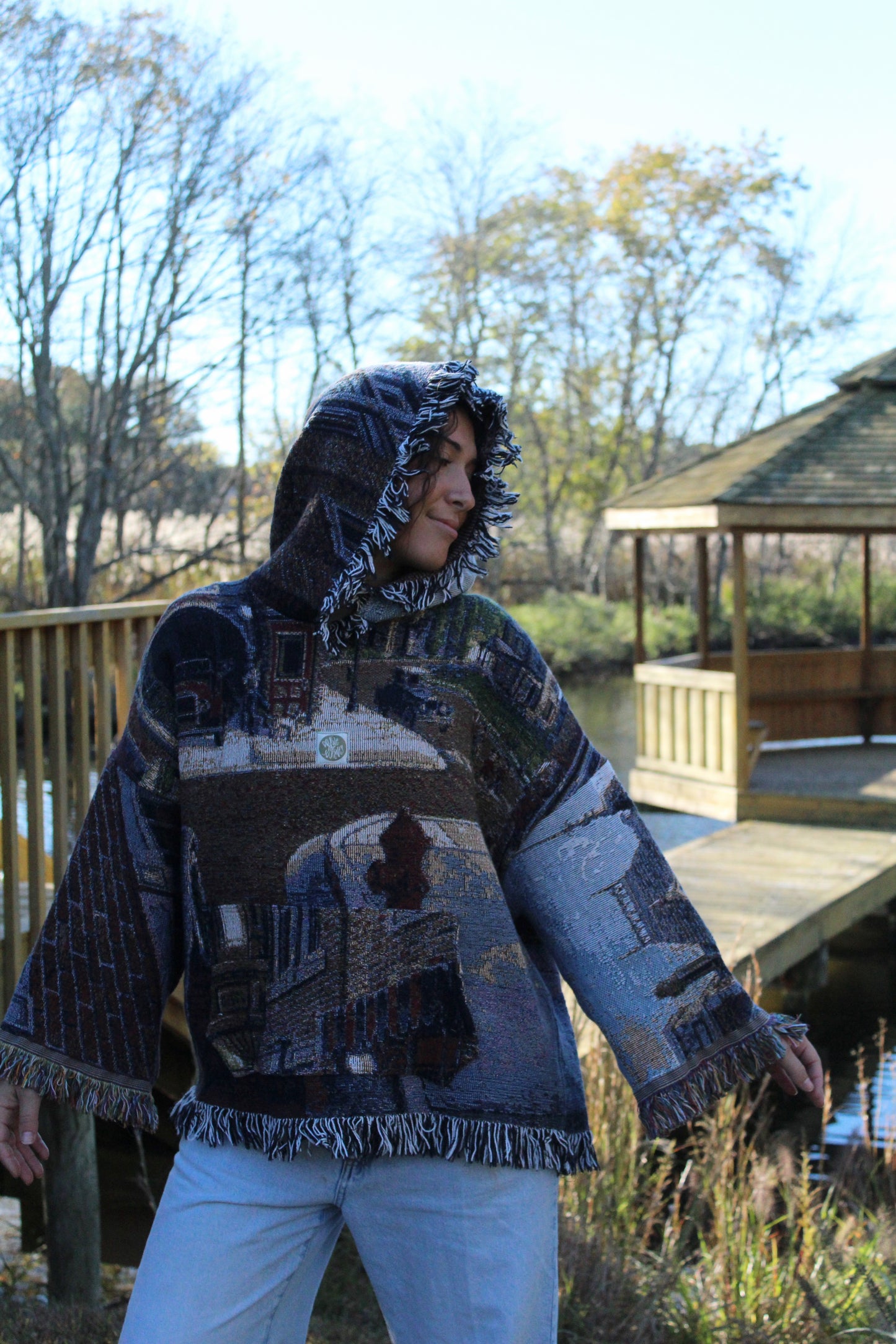 Fringed vintage hoodie with cozy blanket material and picturesque embroidered designs.