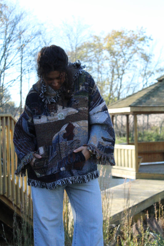Cozy vintage-style hoodie made from a patterned blanket, finished with fringe edges.