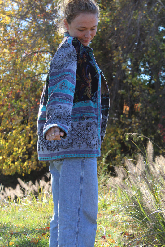 Textured blue burlap jacket with embroidered-style floral details and cool retro buttons.