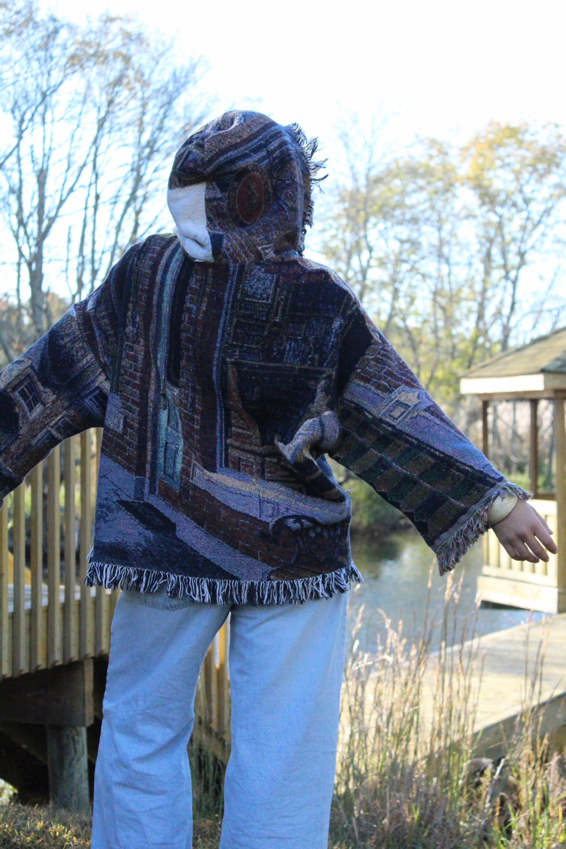 One-of-a-kind vintage hoodie with detailed blanket patterns and soft fringe accents.