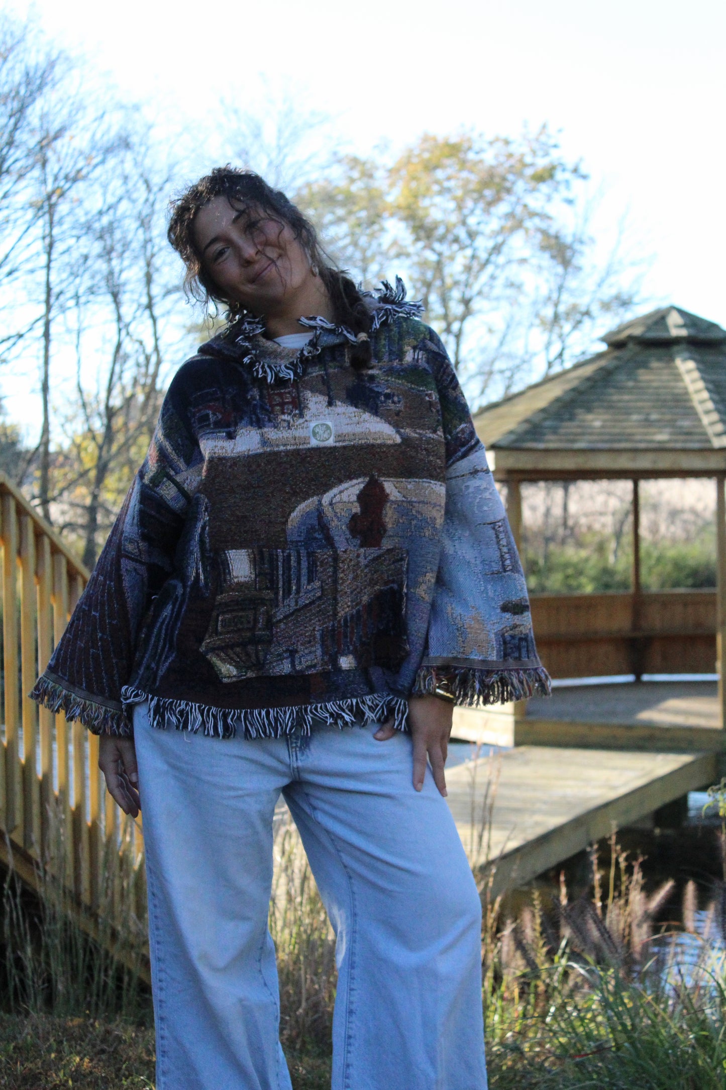 Vintage blanket hoodie with fringe trim and intricate, picturesque woven detailing.