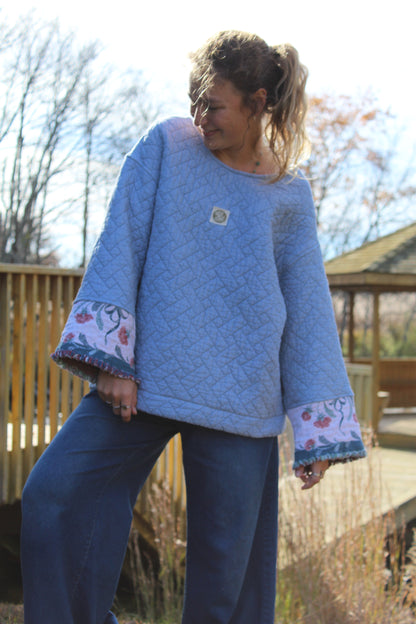 One-of-a-kind blue vintage quilt crewneck with floral fringe accents at the cuffs