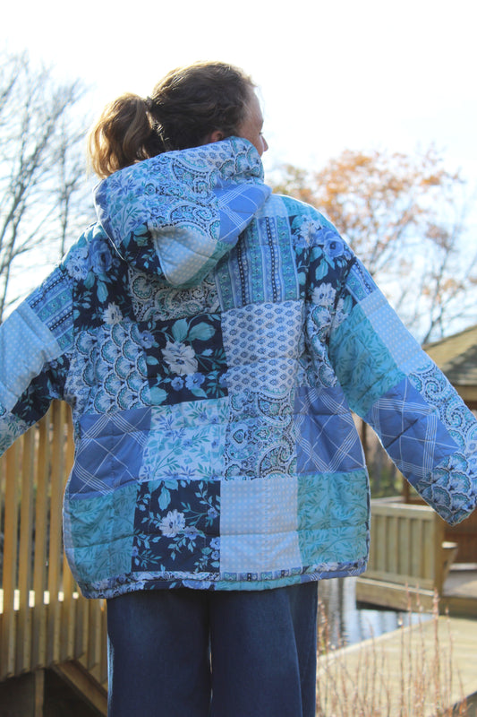 Upcycled hoodie featuring blue and white quilted fabric and unique stitched detailing.
