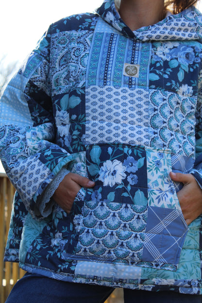 Cozy blue quilted hoodie with patterned squares and repurposed vintage materials