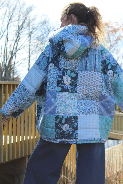 Sustainable fashion piece — blue upcycled hoodie crafted from a vintage patchwork quilt