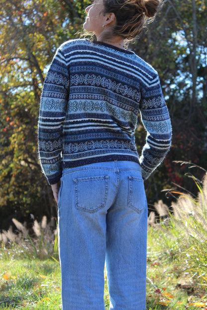 Blue knit zip-up sweater with an all-over pattern and soft texture.