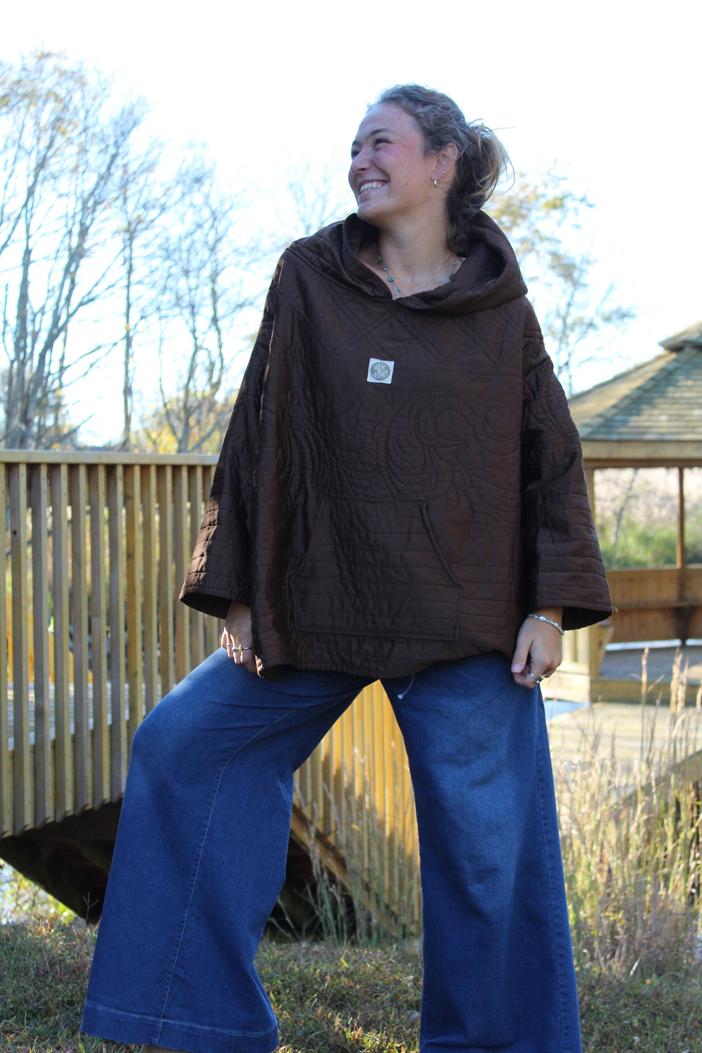 Vintage-inspired brown hoodie featuring soft quilted fabric and floral embroidered accents.