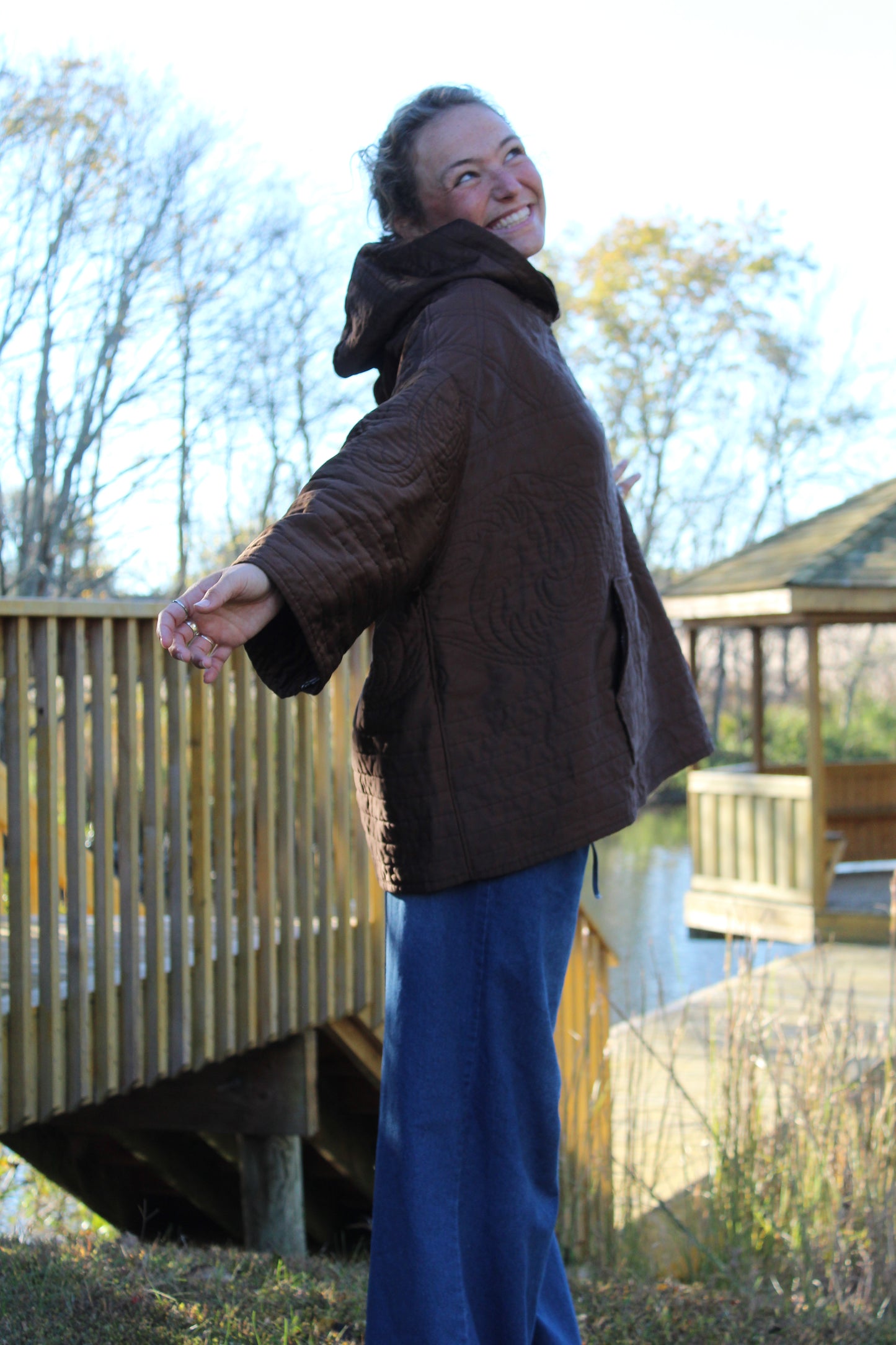 Textured brown hoodie with quilted panels and glimmering silk-thread flower embroidery.