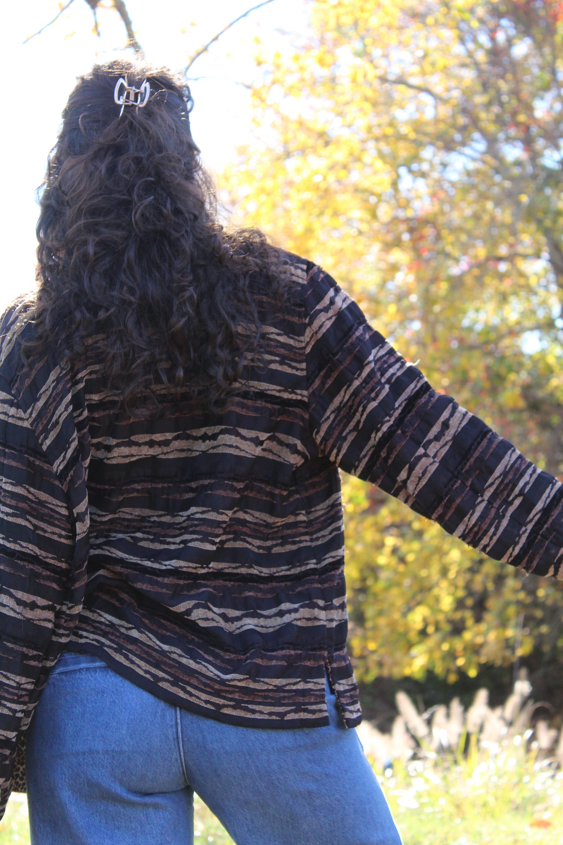 Vintage-style brown jacket with bold zebra and cheetah mixed prints.