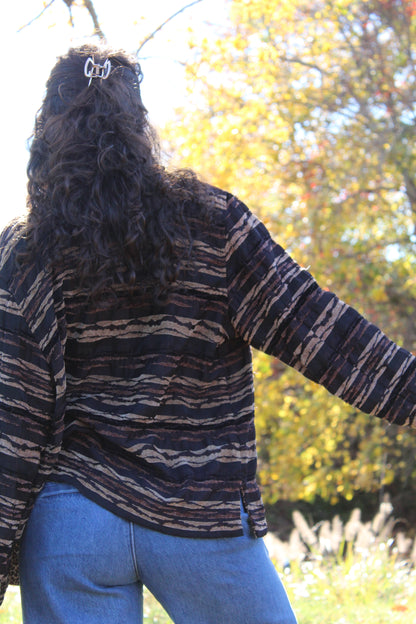 Vintage-style brown jacket with bold zebra and cheetah mixed prints.