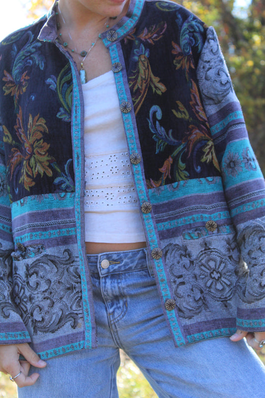 Blue burlap jacket featuring a floral design and unique vintage buttons down the front.