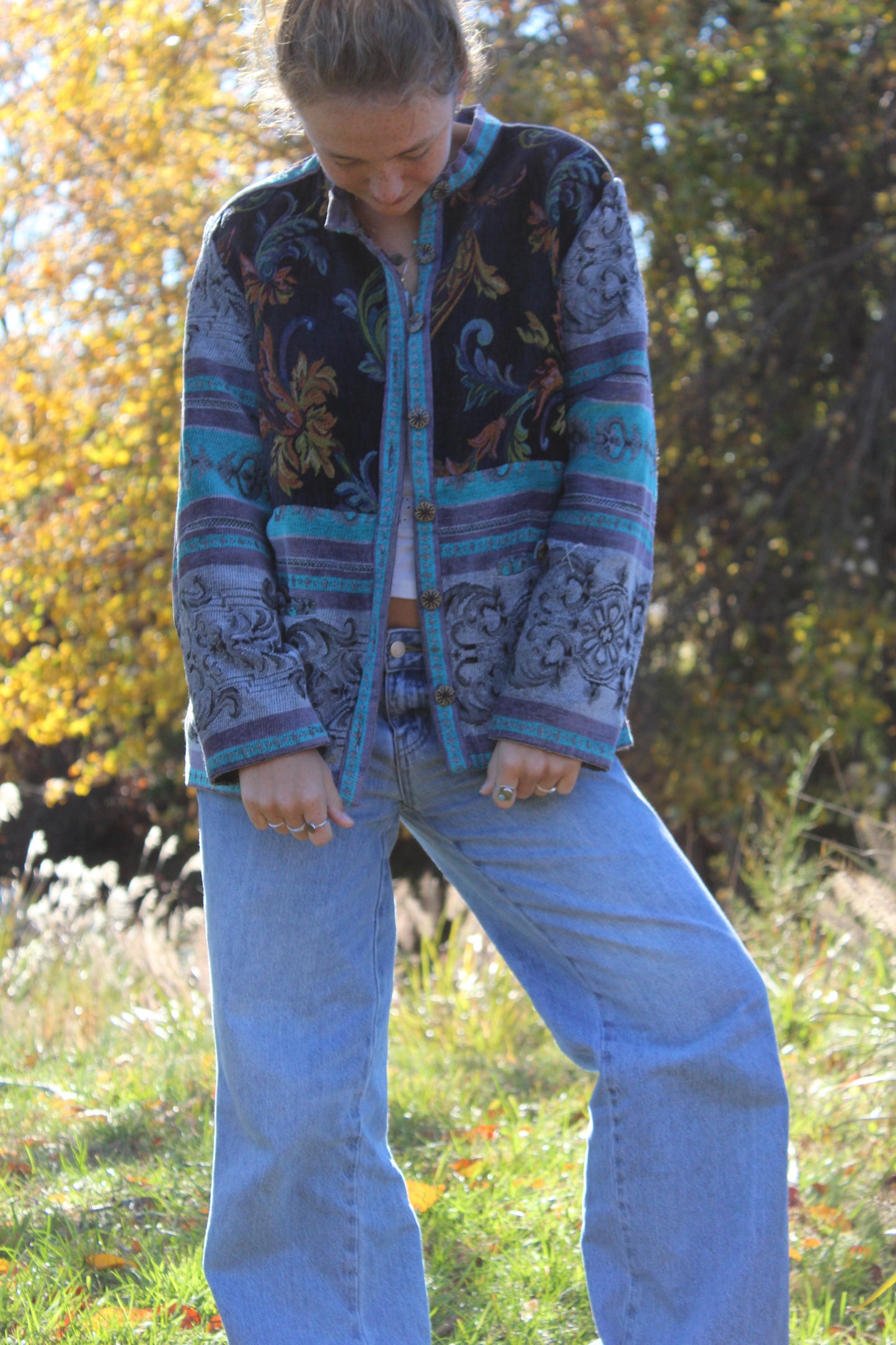 Front view of a blue burlap floral jacket accented with standout vintage buttons.