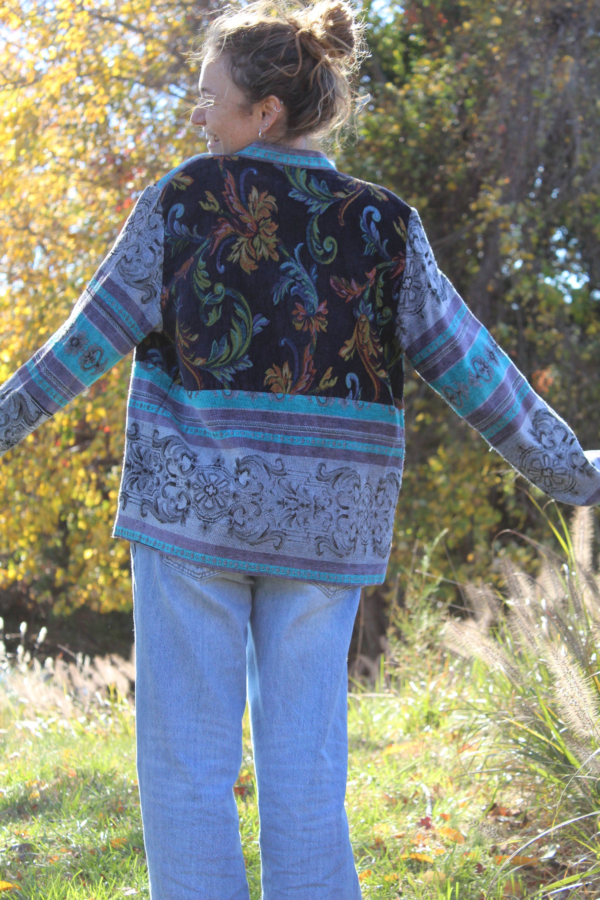 Handcrafted blue burlap jacket with bold floral patterns and mismatched vintage button closures.