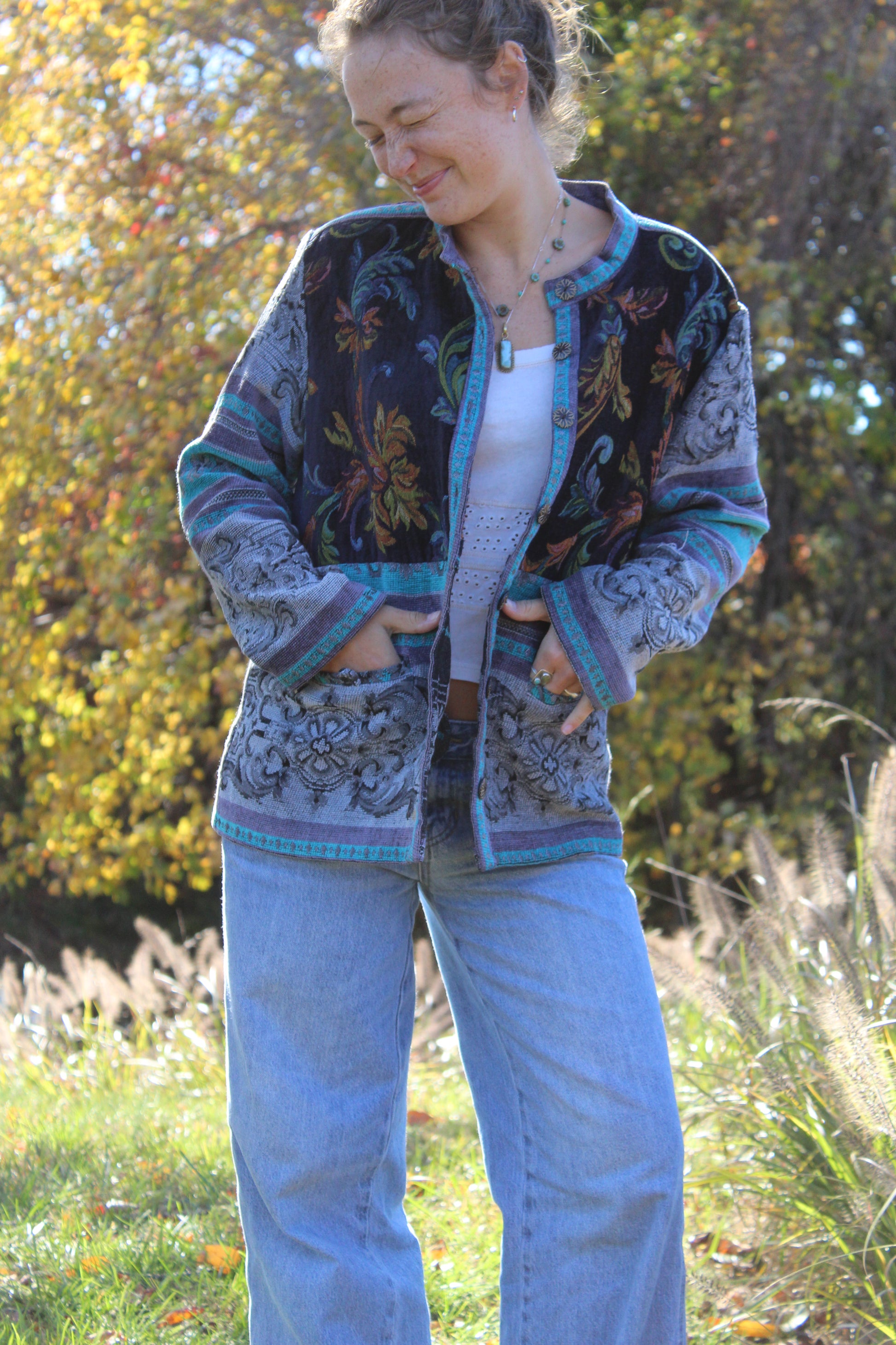 Unique blue burlap jacket with soft floral motifs and collectible vintage buttons on the front.