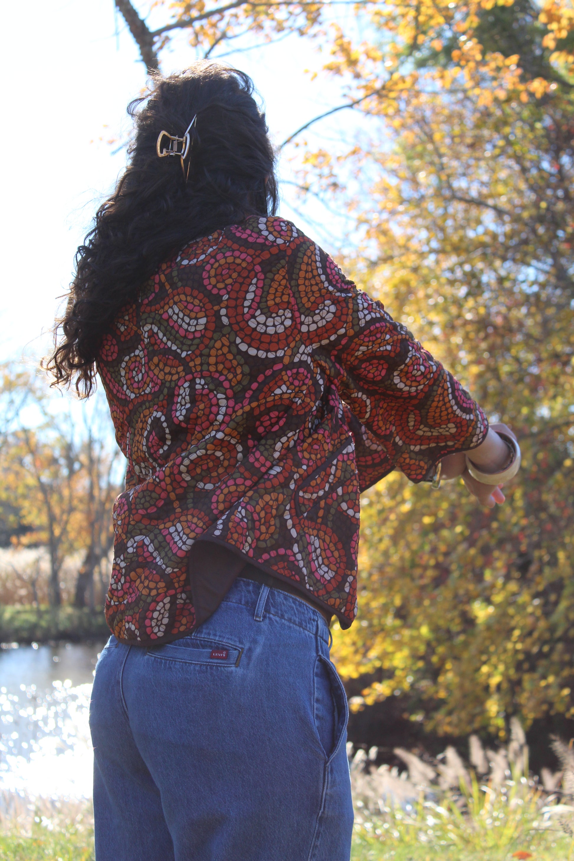 Colorful orange and red polka dot quilted button-up with a soft, lightweight feel.
