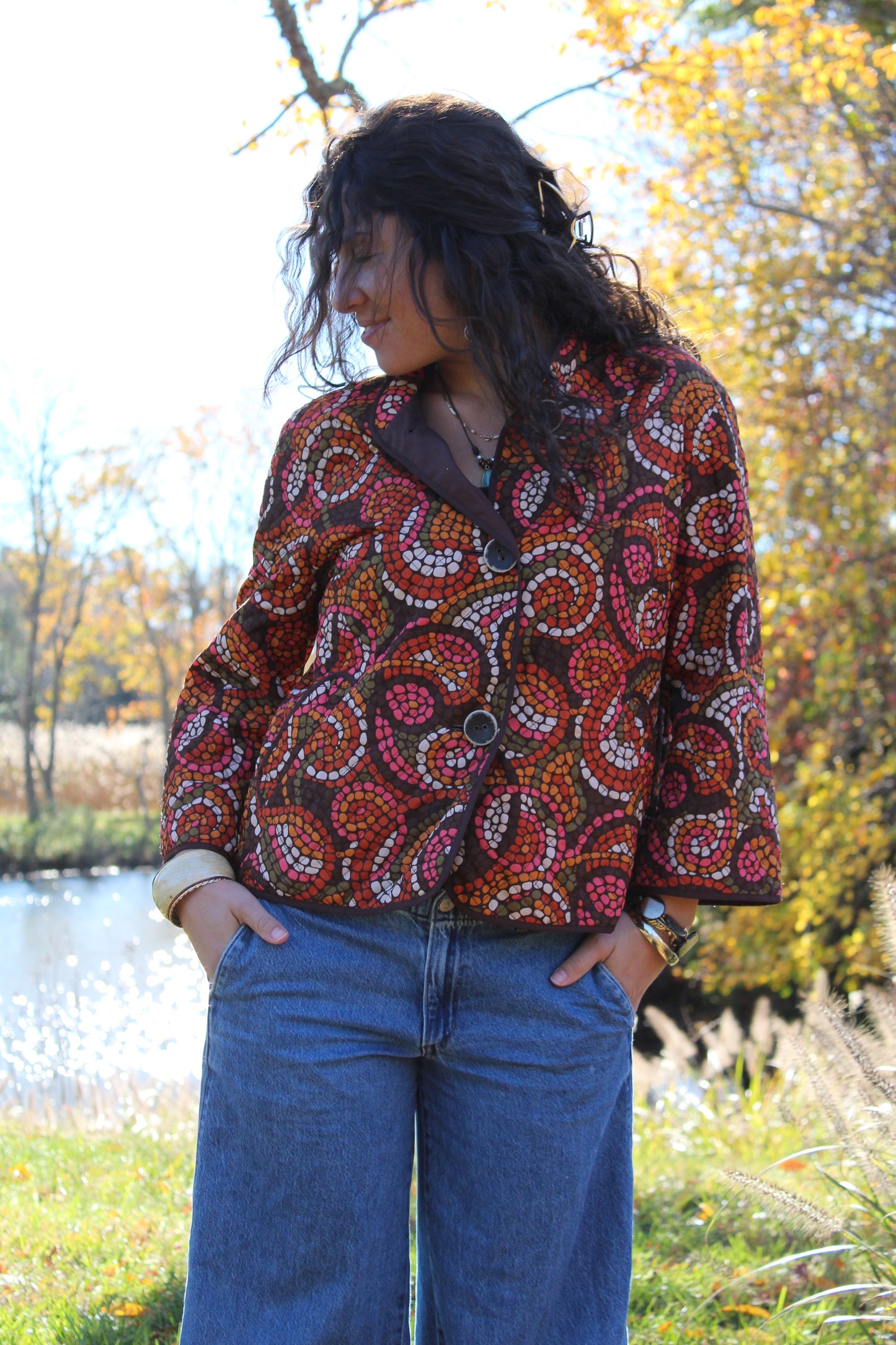 Orange and red polka dot button-up made from thin quilted material.