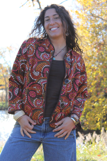 Lightweight quilted button-up featuring bold orange and red polka dots.