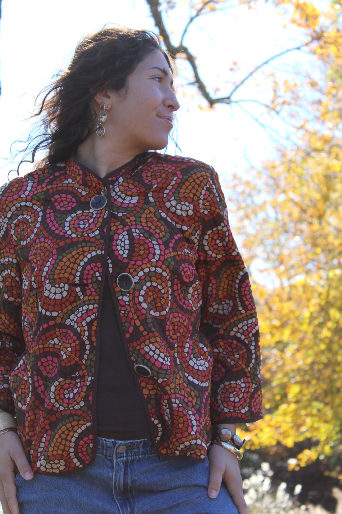 Vintage-inspired thin quilt top with orange and red dot patterns and buttons down the front.