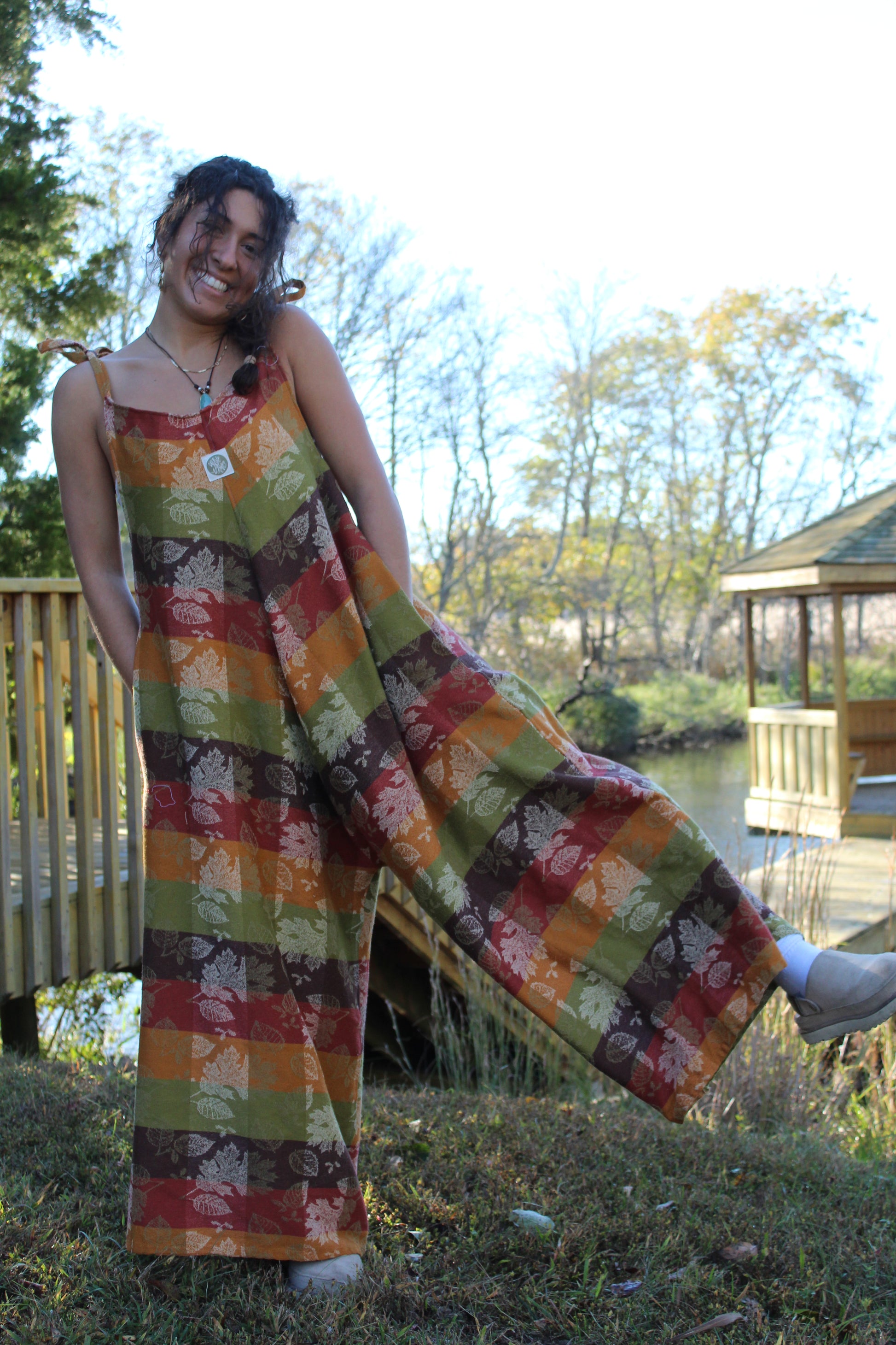 Handmade fall jumpsuit crafted from a vintage floral tablecloth with warm autumn tones.