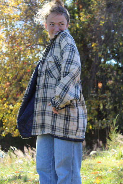 Tan and navy plaid flannel shirt in an extra-oversized silhouette.