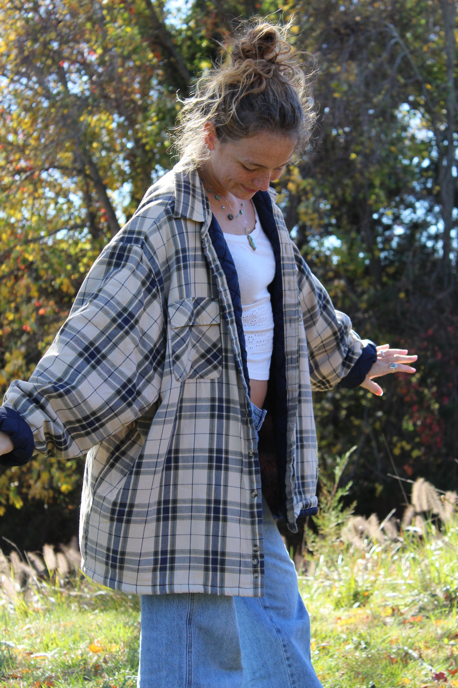 Front view of an oversized tan and navy flannel with classic plaid pattern.