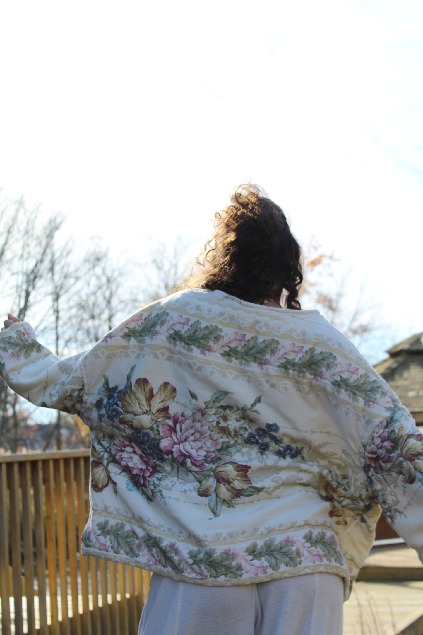 Vintage comforter crewneck showcasing delicate floral patterns and cozy quilted fabric.