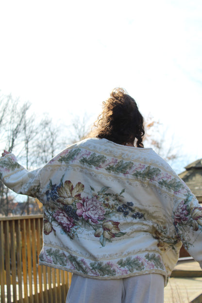 Vintage comforter crewneck showcasing delicate floral patterns and cozy quilted fabric.