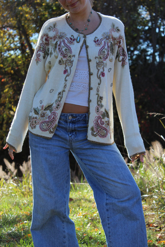 Button-up sweater featuring detailed floral stitching and gold accent trim.