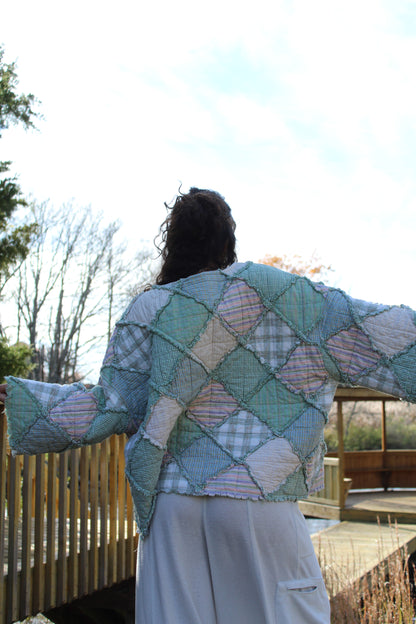 One-of-a-kind green quilted crewneck with cozy patchwork detailing