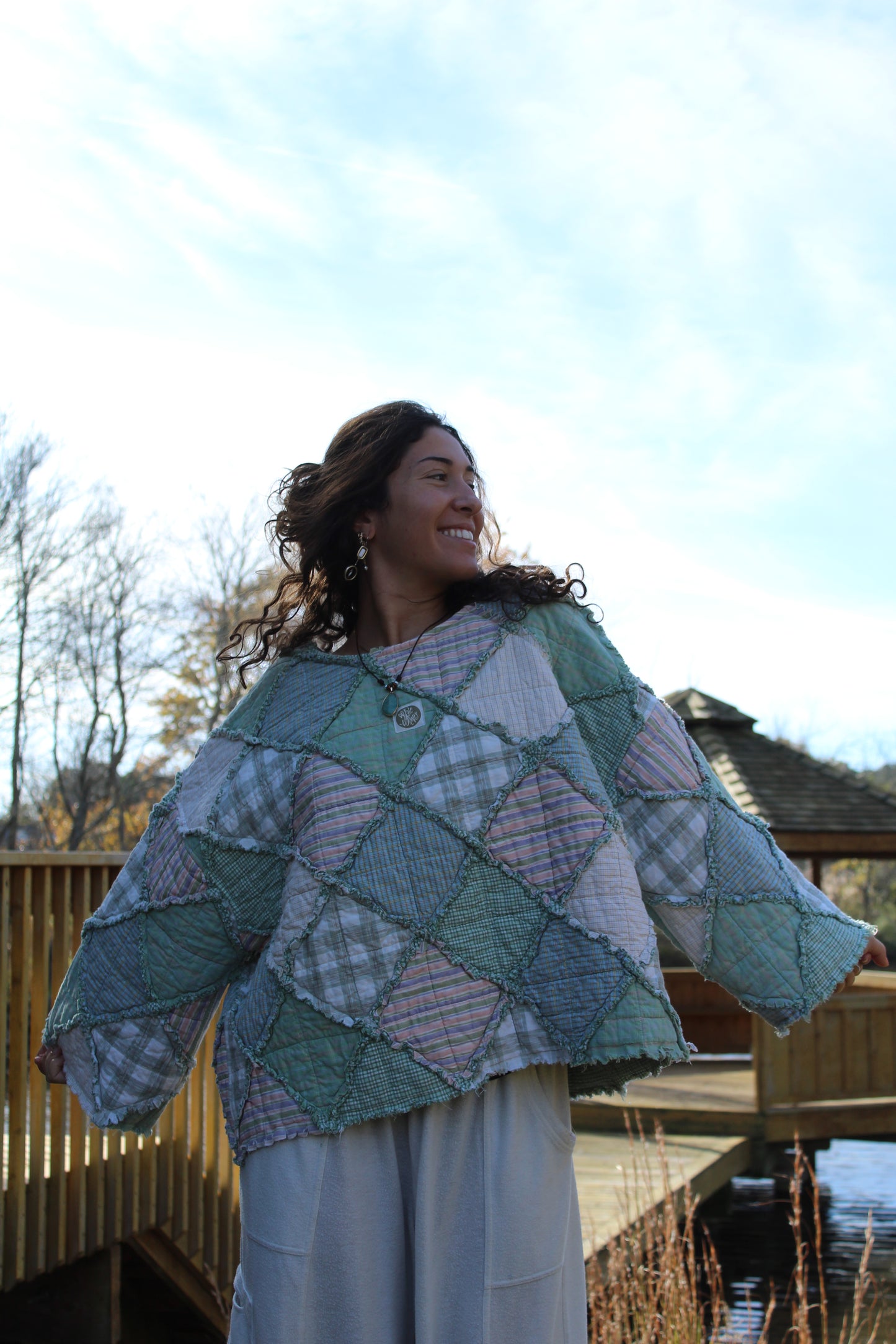 Sustainable handmade crewneck with unique green patchwork panels.