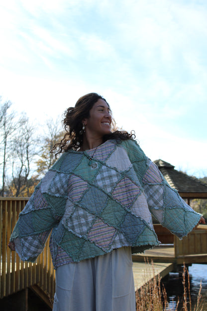 Sustainable handmade crewneck with unique green patchwork panels.