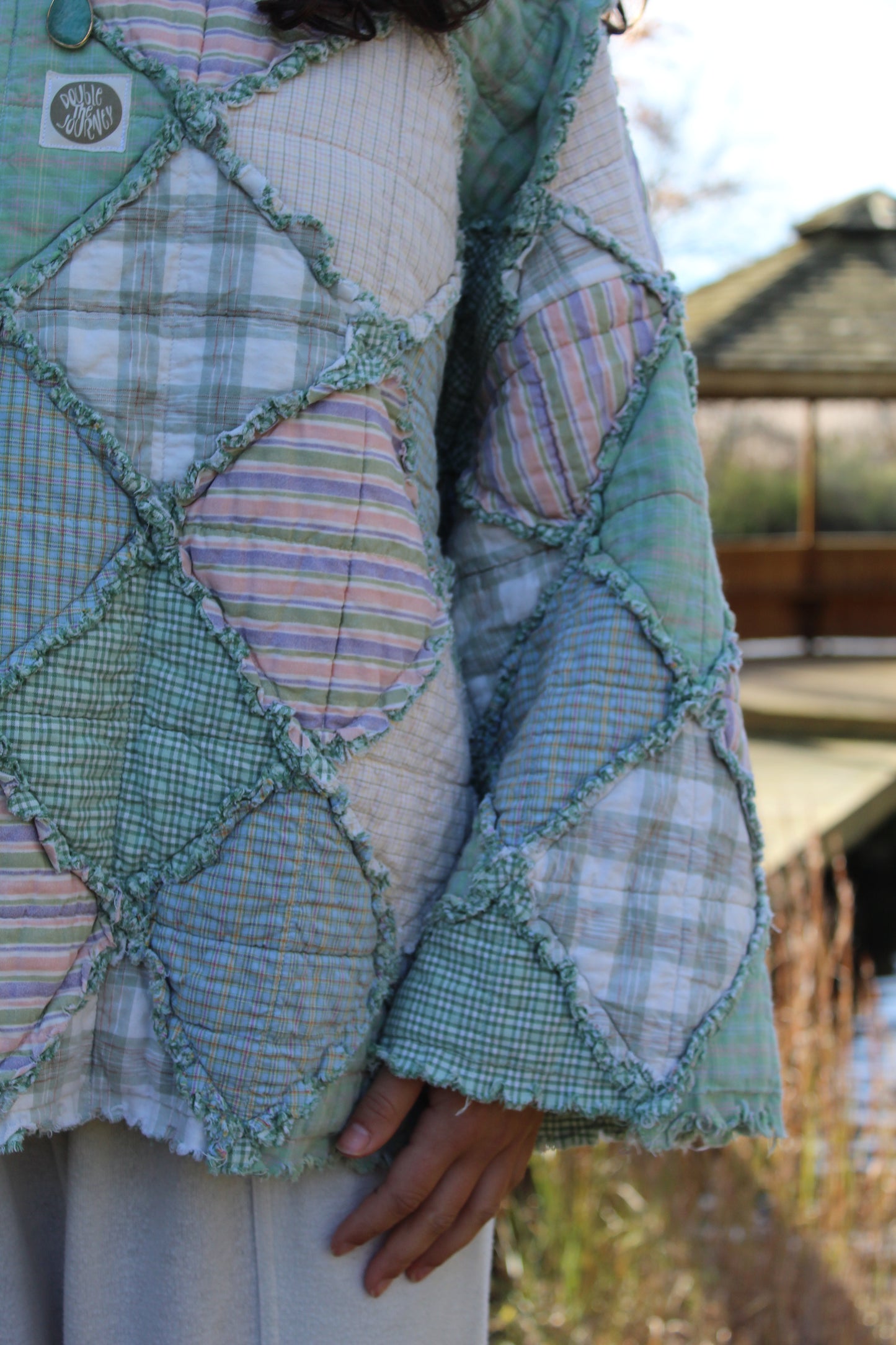 Gorgeous green crewneck made from repurposed vintage textiles with patchwork details.