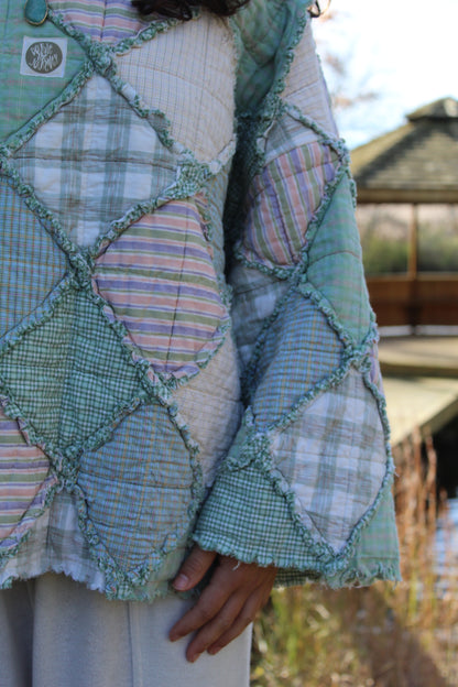 Gorgeous green crewneck made from repurposed vintage textiles with patchwork details.