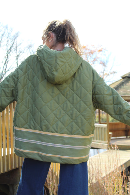 “Men’s large green hoodie made from repurposed fabric with yellow stripe detail.”