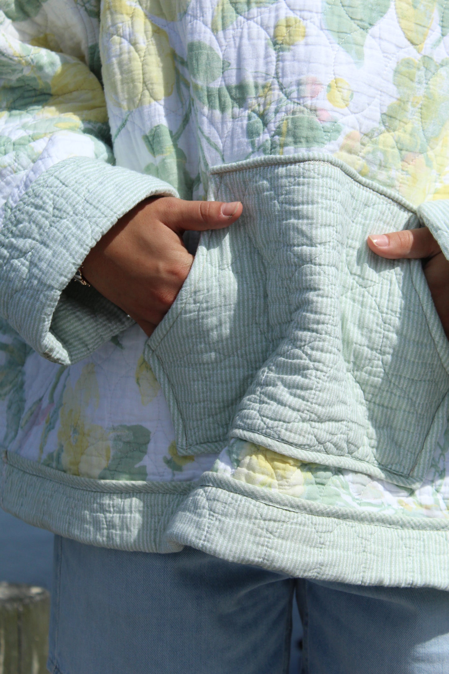 close up of green vintage quilted hoodie with large front pocket
