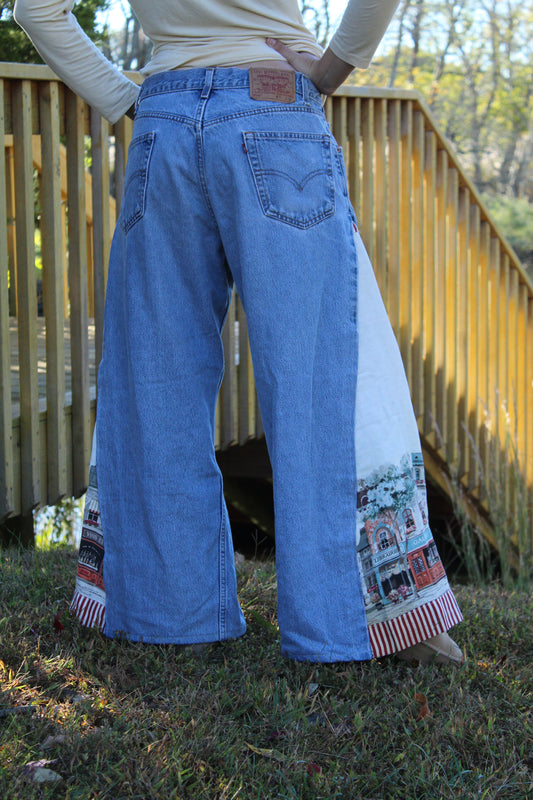 Vintage Levi’s jeans with upcycled side panels featuring a European picture scene design