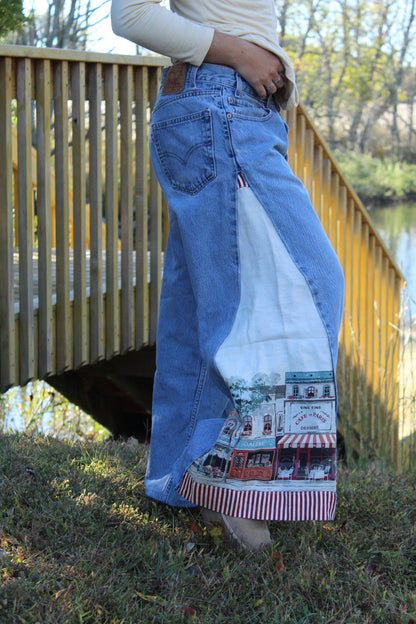 Upcycled Levi’s denim with woven side inserts showing a vintage European village scene