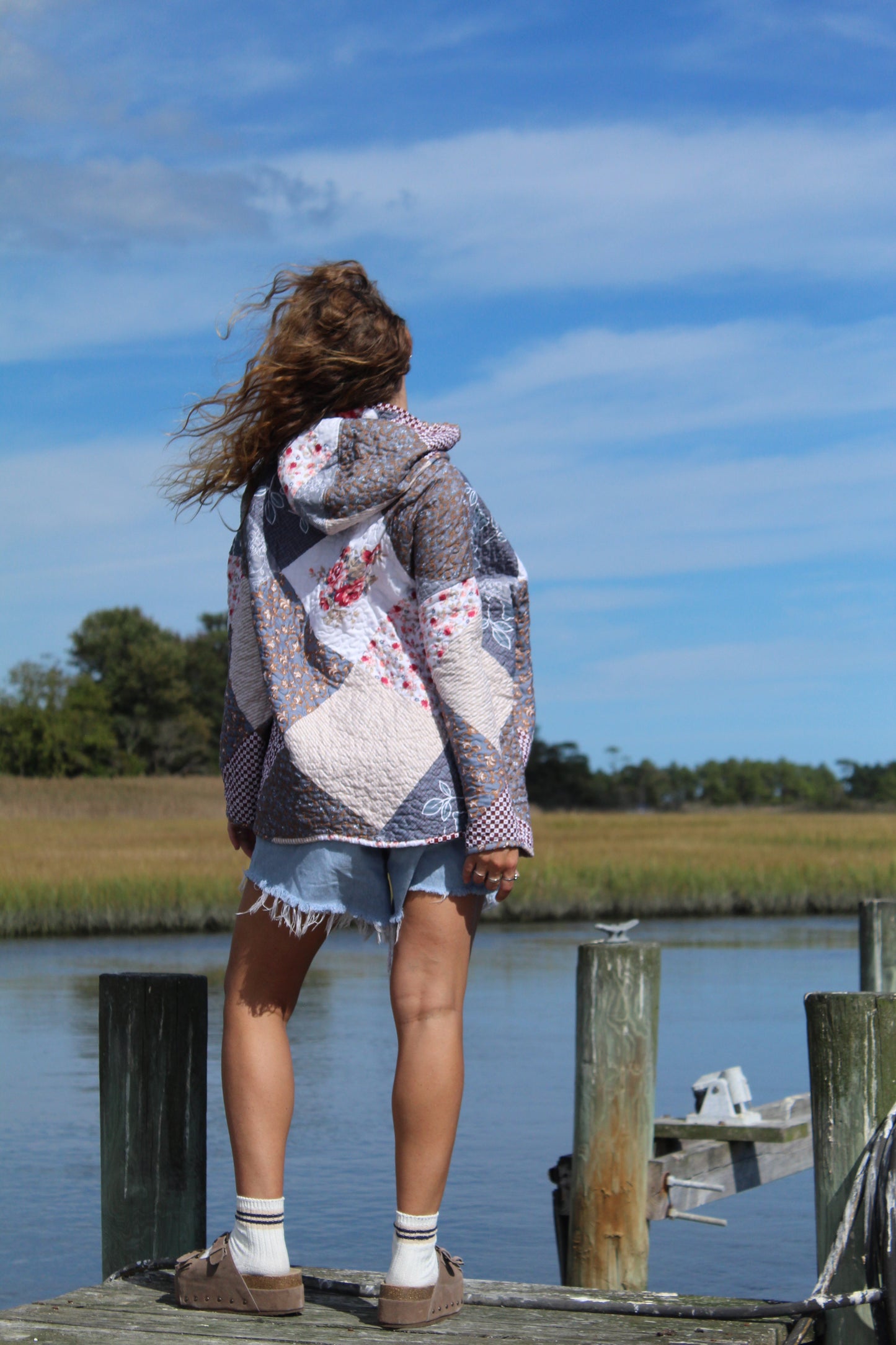 back of quilted hoodie featuring patchwork design
