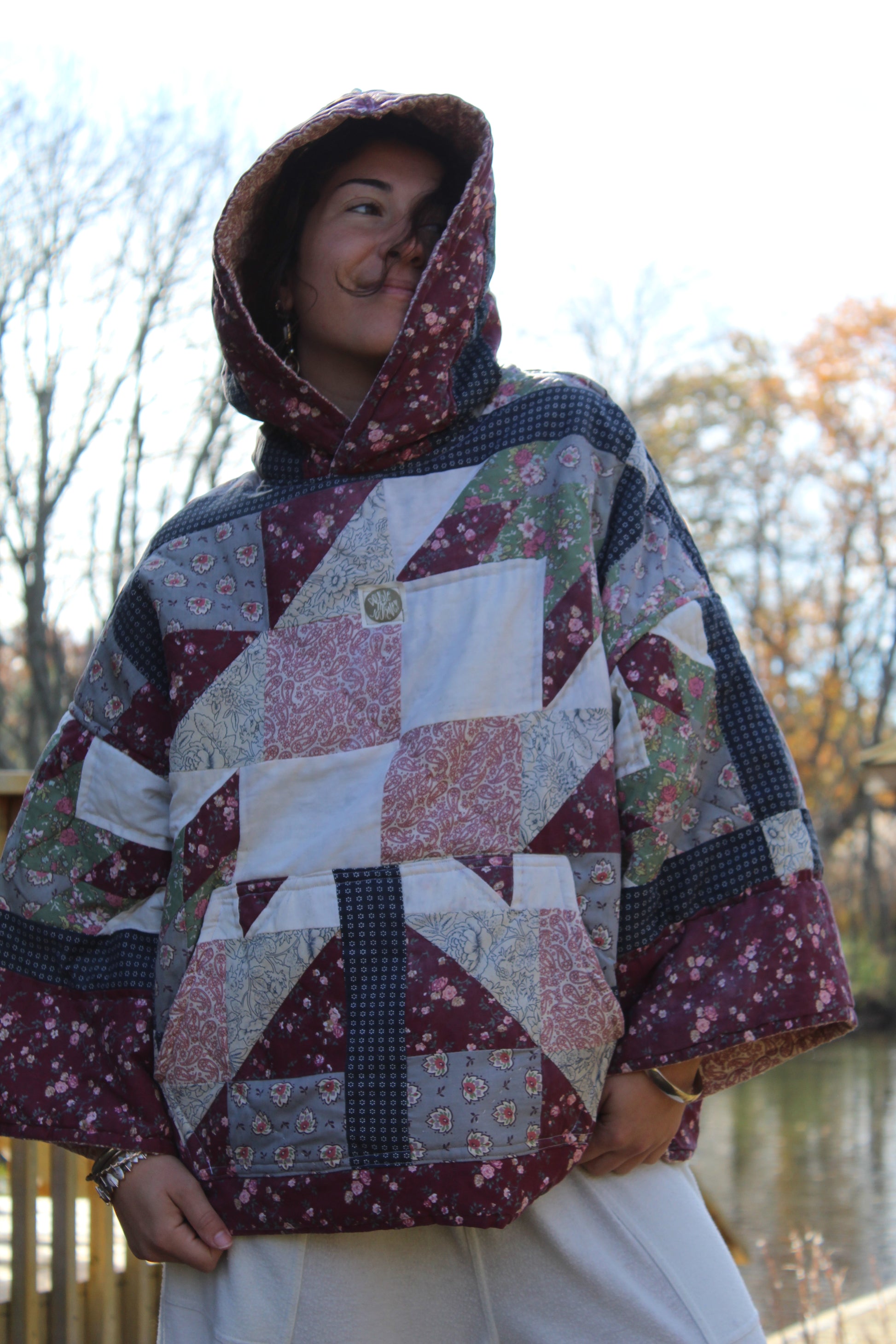 Vintage quilted handmade hoodie featuring dark red and blue patchwork details.