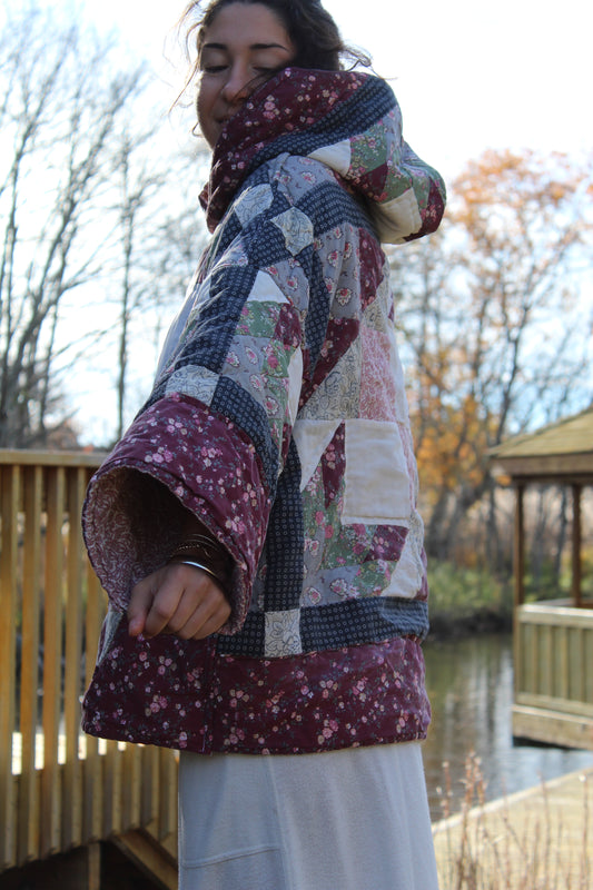 Upcycled hoodie made from a vintage quilt with deep red and navy blue quilted patterns.