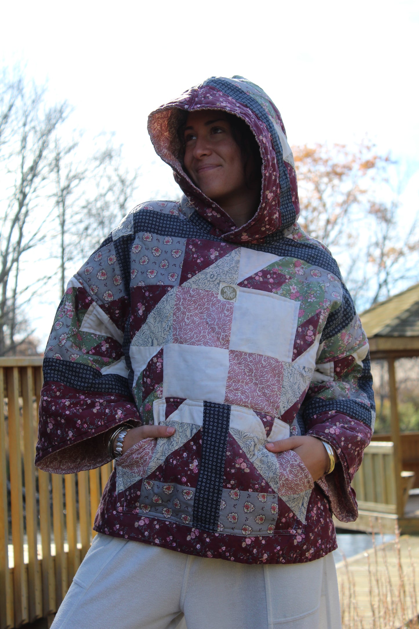 Handcrafted hoodie from repurposed quilt, showcasing red and blue patchwork design