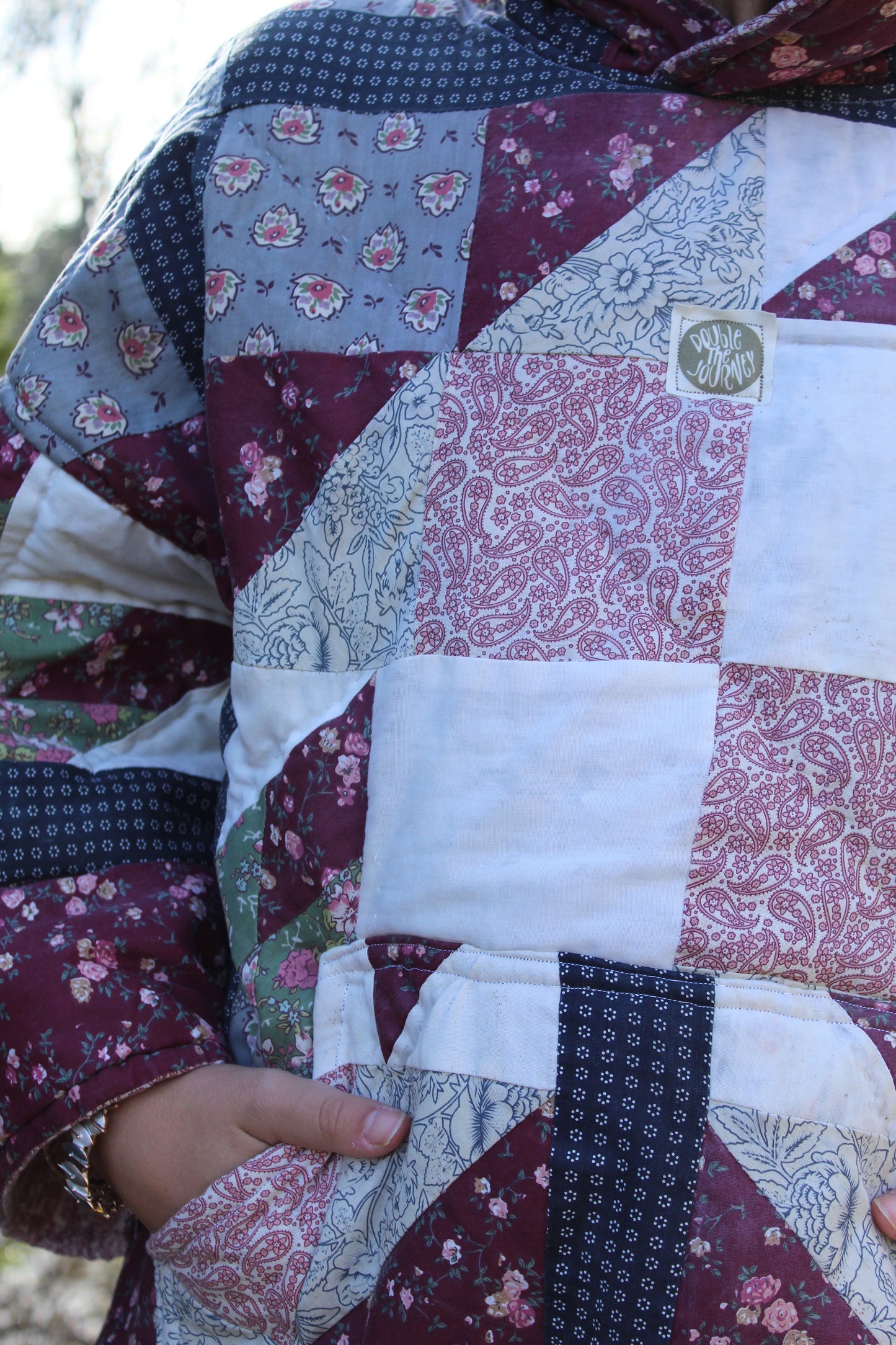 One-of-a-kind quilted hoodie with dark red and blue vintage fabric squares.