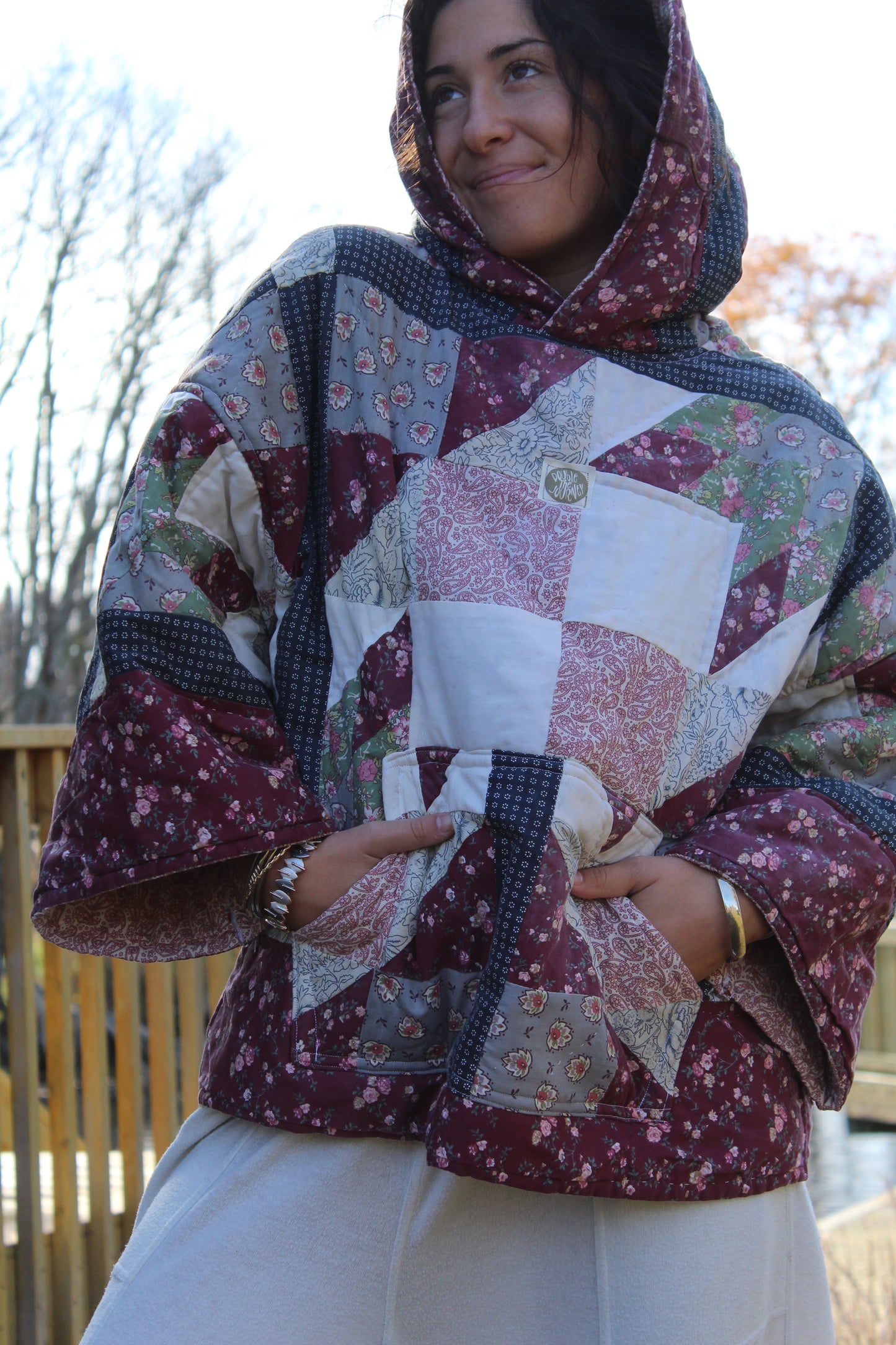 Sustainable upcycled hoodie made from a vintage quilt in dark red and blue tones.