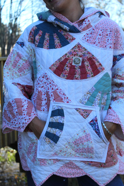 close up pink quilted hoodie with patterned details and pocket