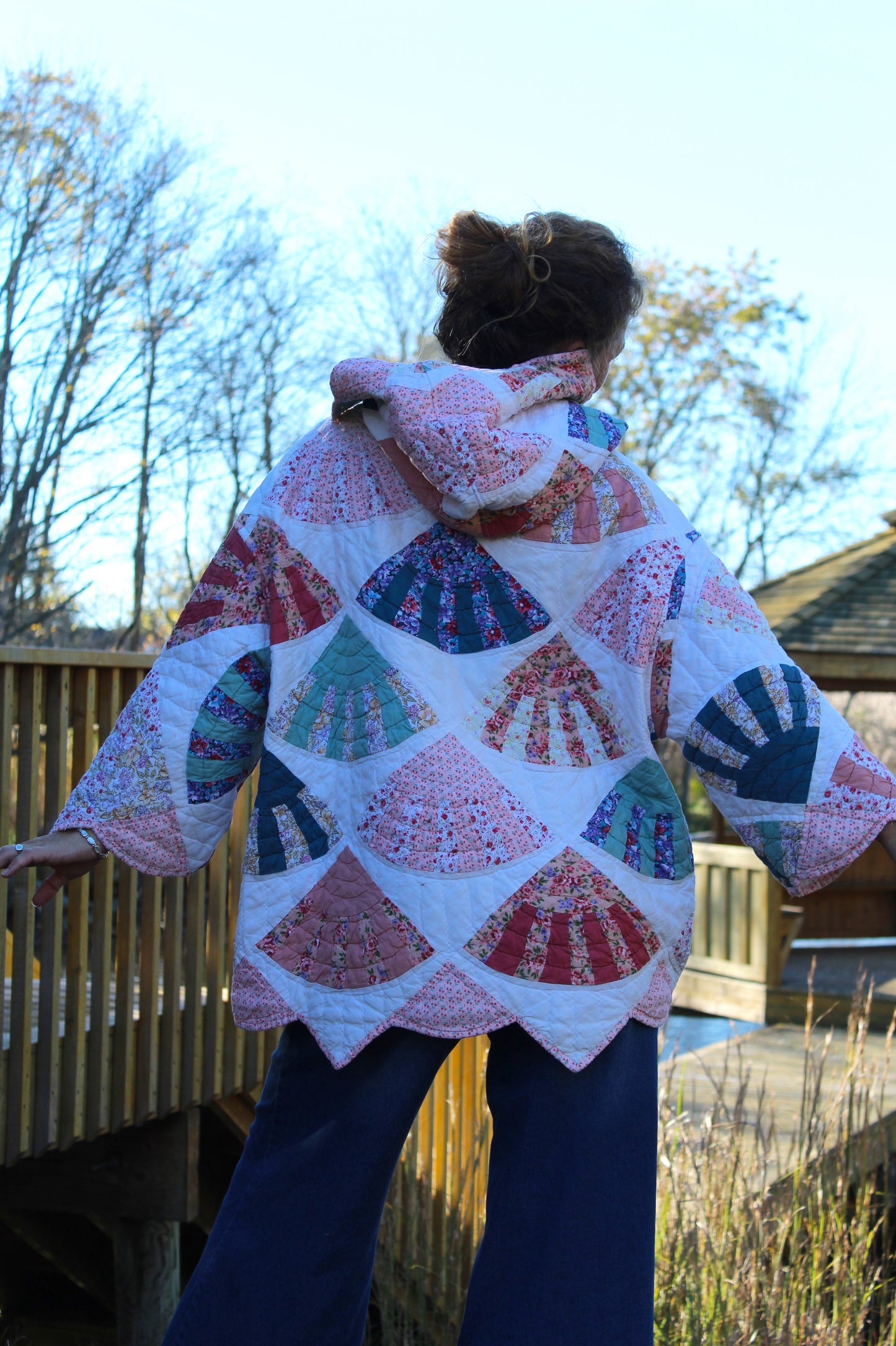 pink quilted hoodie from the back with scalloped details