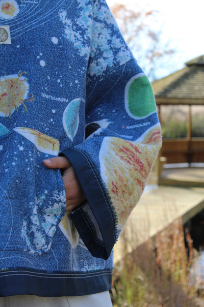 Vintage blanket hoodie featuring colorful planets, rockets, and cosmic patchwork