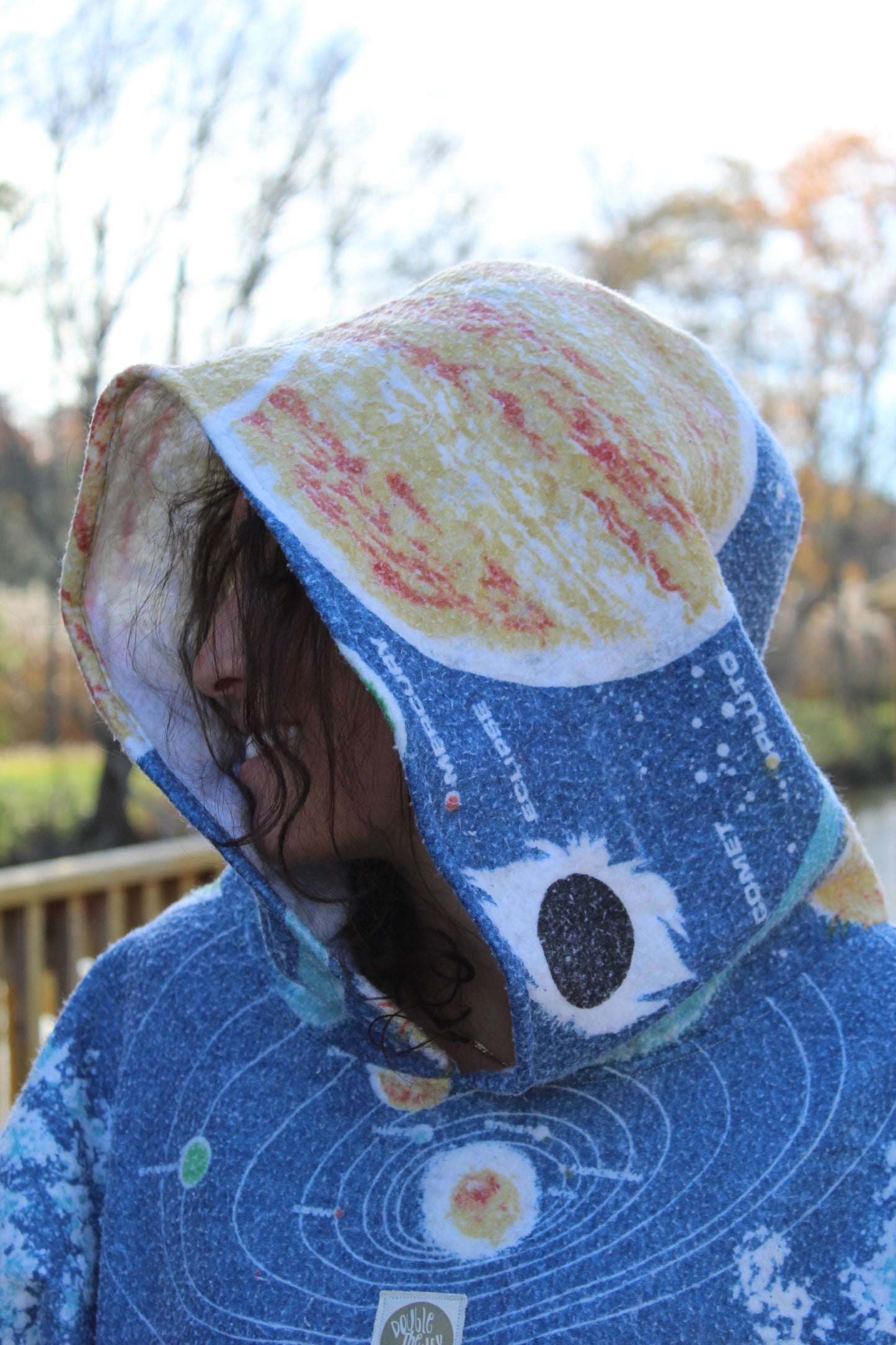 Unique upcycled hoodie made from soft space-themed blanket with bold celestial patterns.