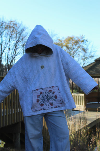 Handmade vintage hoodie featuring quilted texture, soft blue stripes, and floral trim pocket