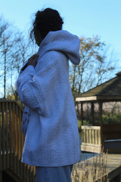 Quilted hoodie crafted from vintage fabric with subtle blue stripes and a dainty floral pocket