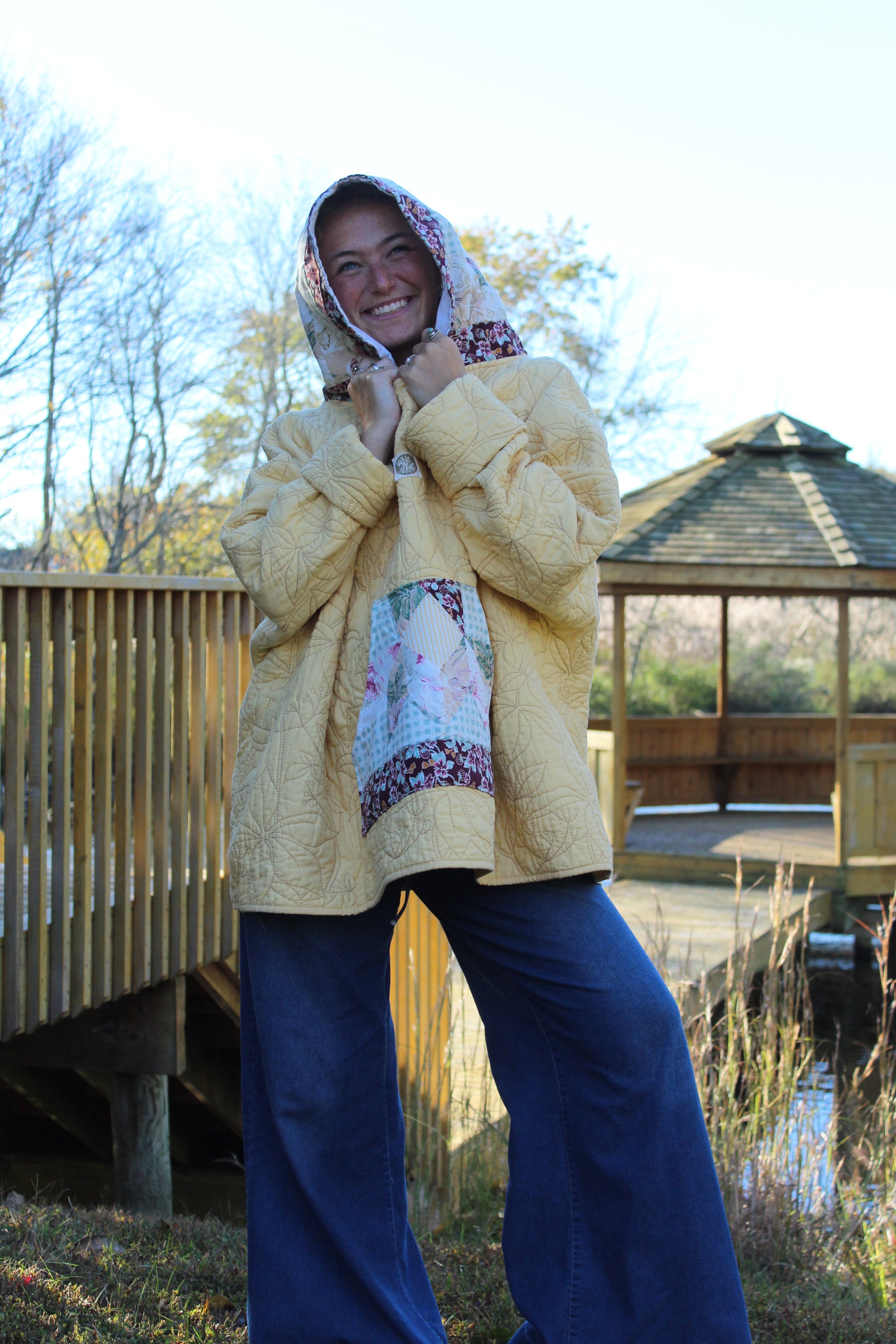 Vintage-inspired yellow hoodie with floral embroidery and patterned hood and pockets